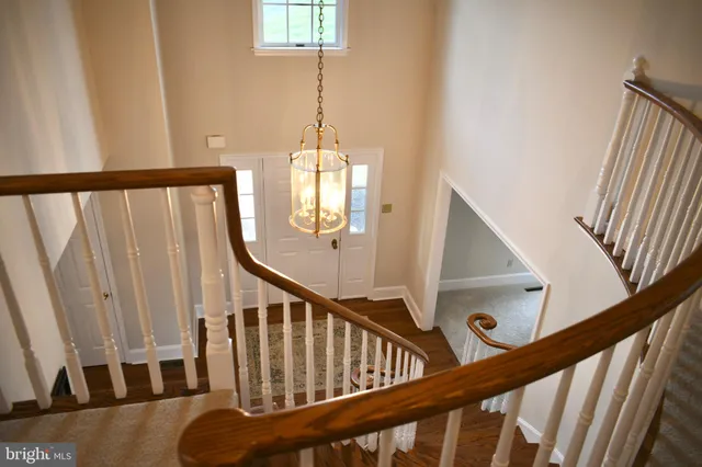 a view of stairs and hall with wooden floor
