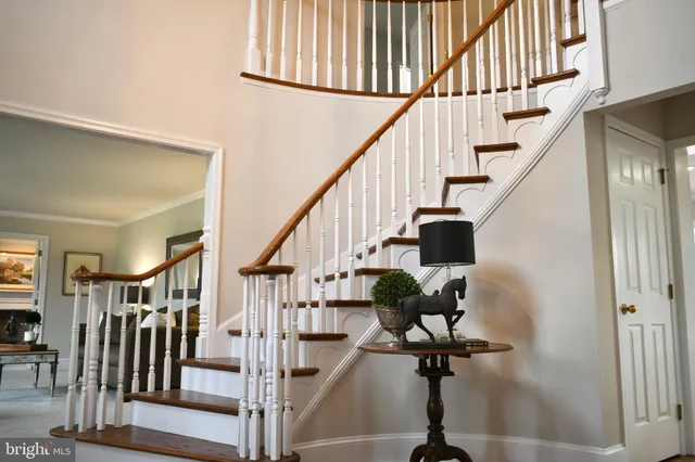 a view of entryway with wooden floor and stairs