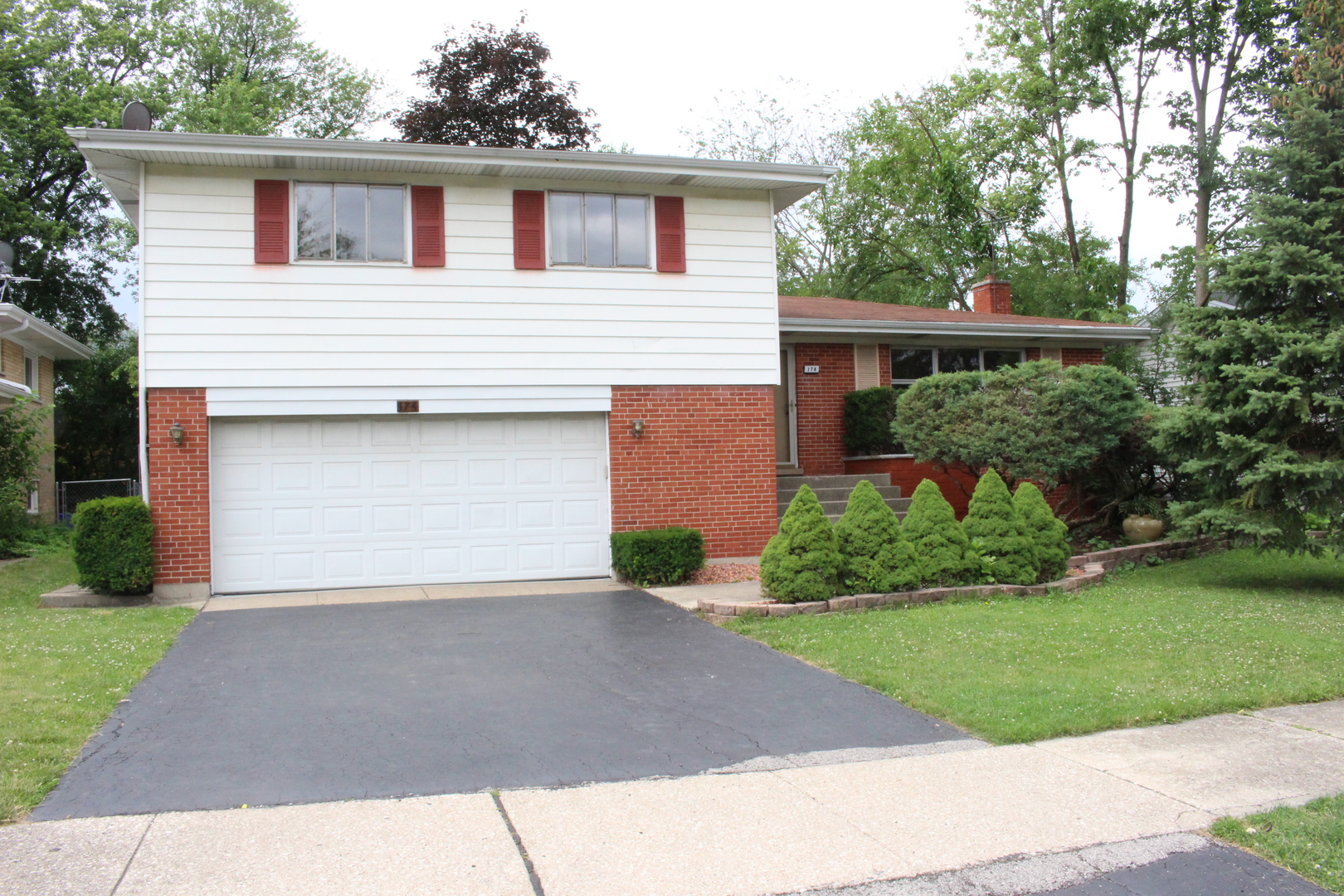 Restricted Address Elmhurst, IL 60126 - Photo 1 of 42 a front view of a house with a yard and garage