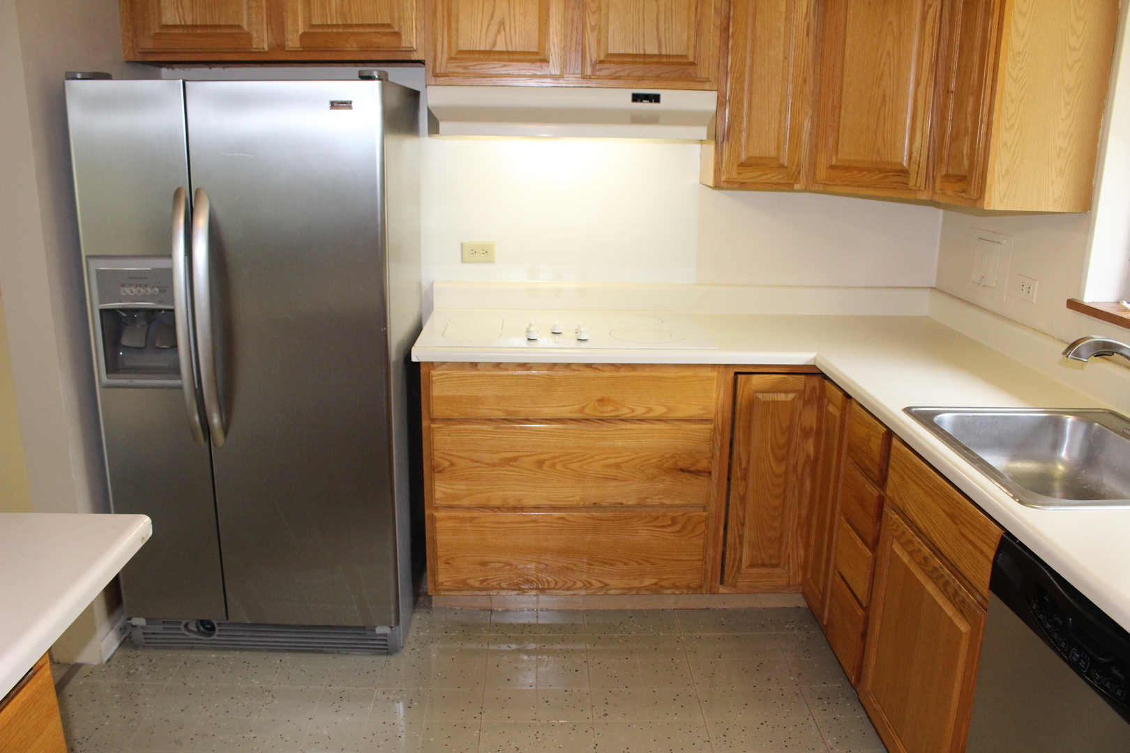 Undisclosed Address Elmhurst, IL 60126 - Photo 11 of 42 a view of a refrigerator in kitchen and an empty room