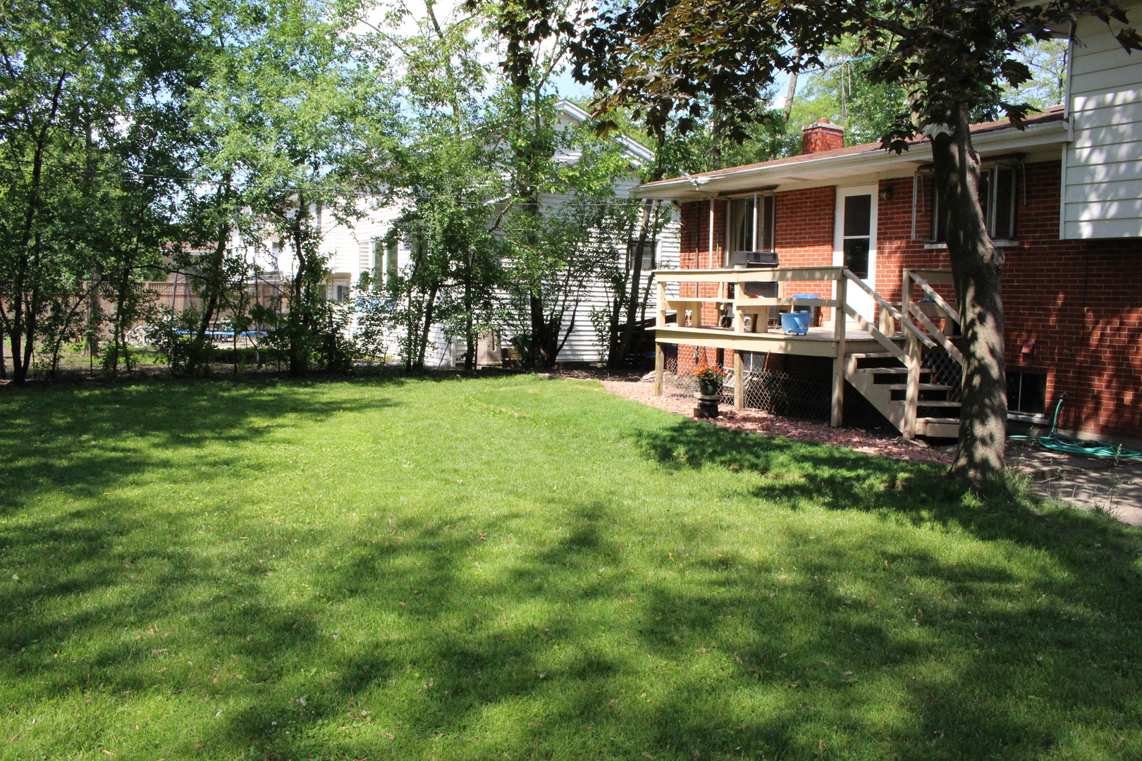 Undisclosed Address Elmhurst, IL 60126 - Photo 27 of 42 a view of a backyard with table and chairs a barbeque and a large trees