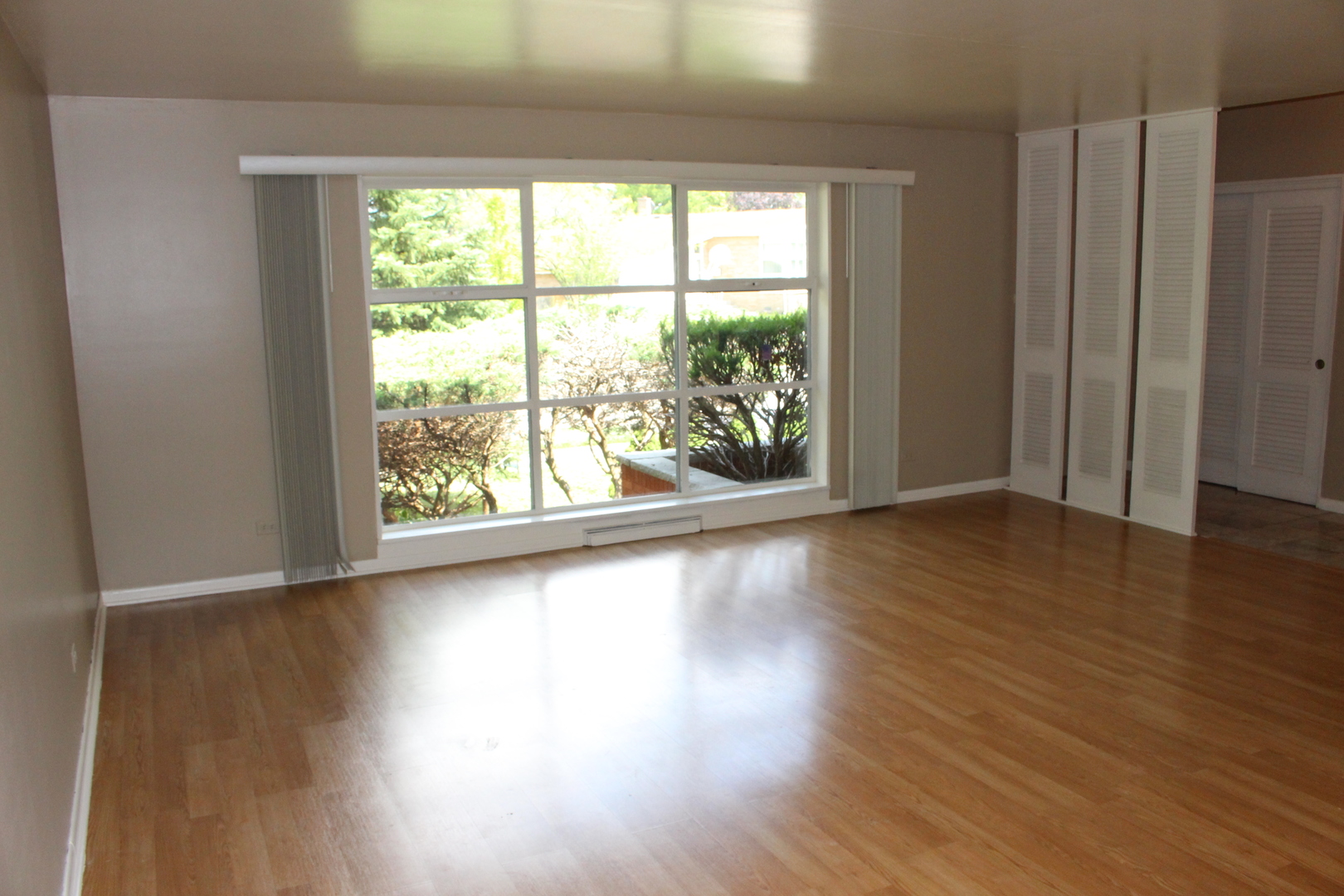 Undisclosed Address Elmhurst, IL 60126 - Photo 5 of 42 a view of an empty room with wooden floor and a window