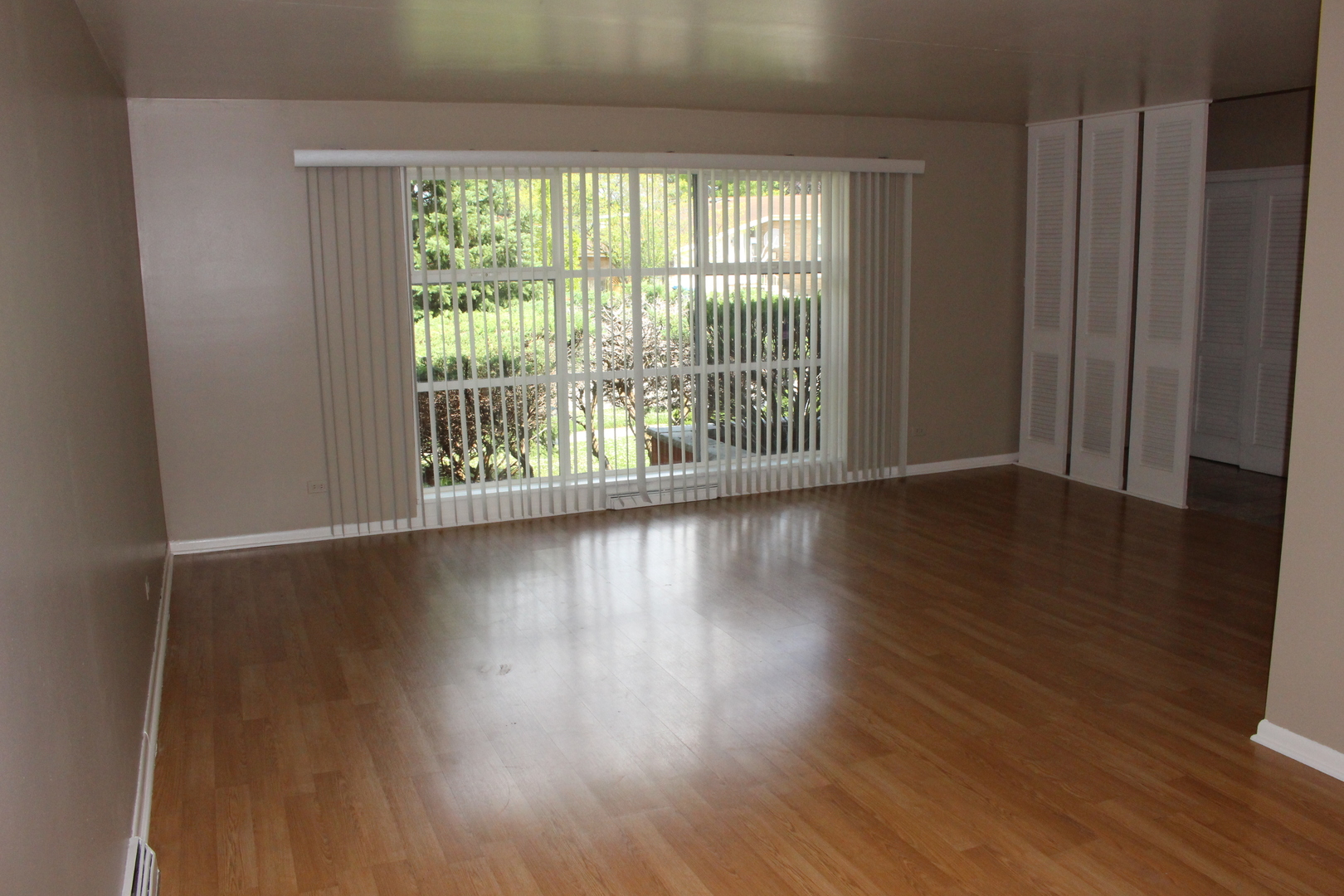 Undisclosed Address Elmhurst, IL 60126 - Photo 6 of 42 a view of an empty room with wooden floor and a window