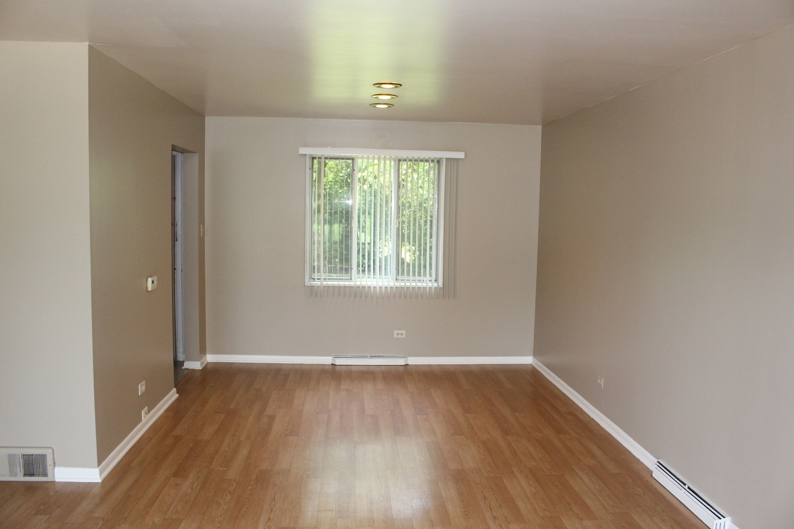 Undisclosed Address Elmhurst, IL 60126 - Photo 10 of 42 an empty room with wooden floor and windows