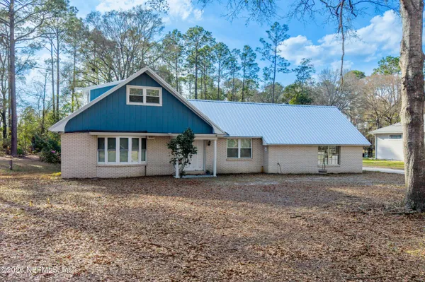 a house that has a tree in front of it