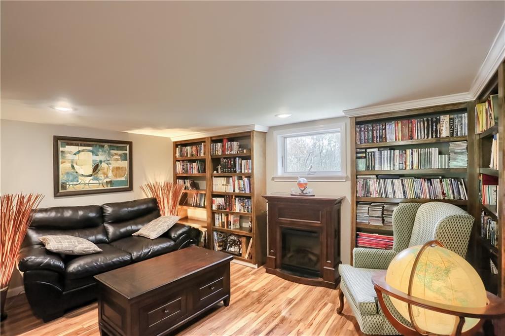 161 B Morgan Road Butler, PA 16002 - Photo 11 of 25 a living room with furniture a fireplace and a book shelf