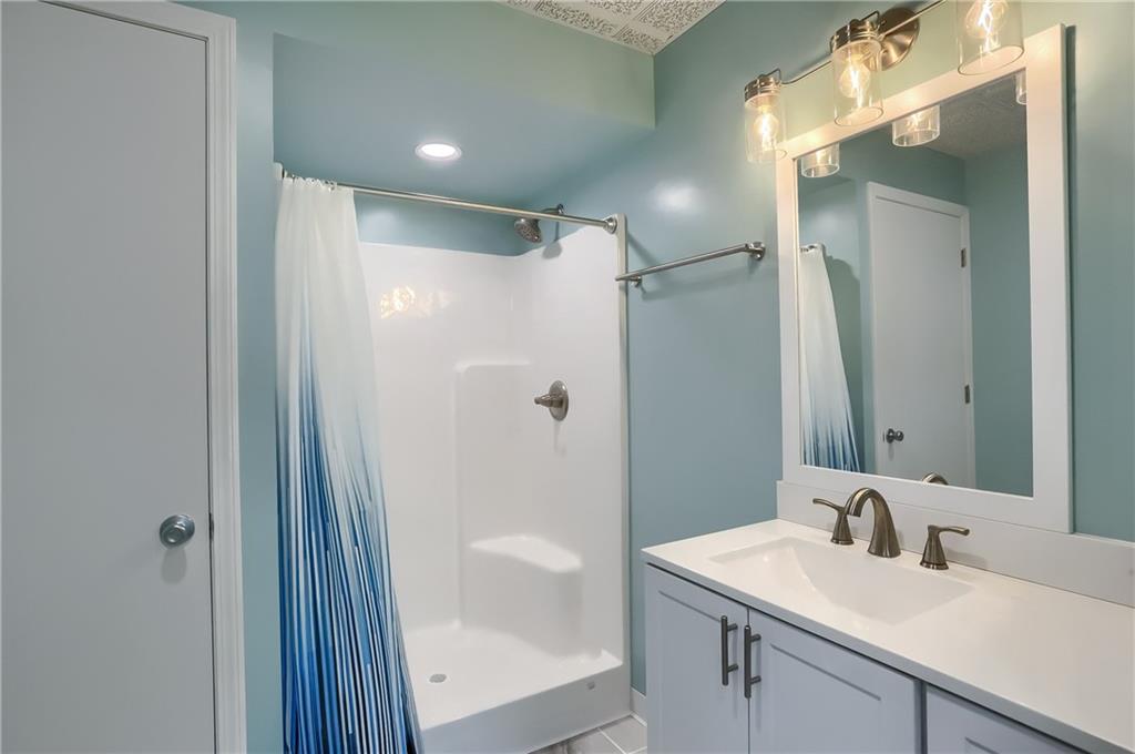 161 B Morgan Road Butler, PA 16002 - Photo 24 of 25 a bathroom with a shower sink vanity and mirror
