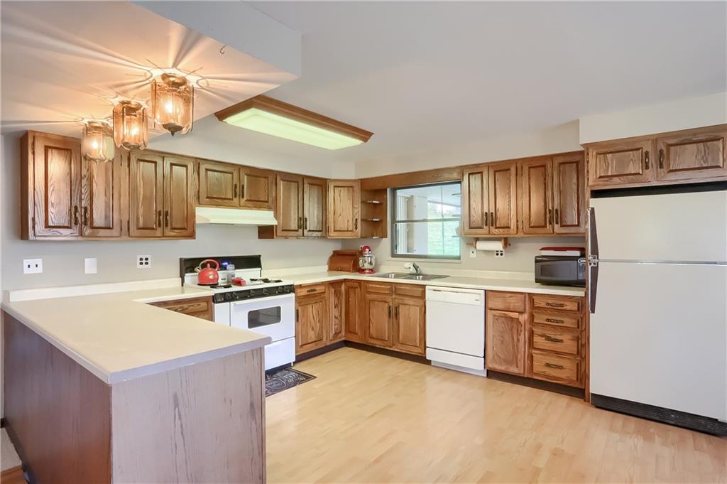 161 B Morgan Road Butler, PA 16002 - Photo 4 of 25 a kitchen with stainless steel appliances granite countertop a stove refrigerator sink and cabinets