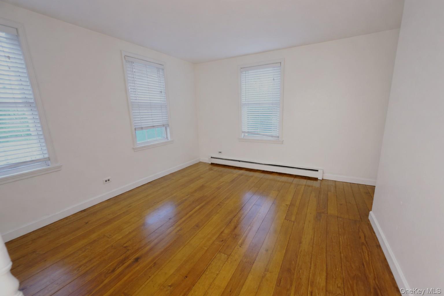 60 Main Street Tappan, NY 10983 - Photo 13 of 22 an empty room with wooden floor and windows