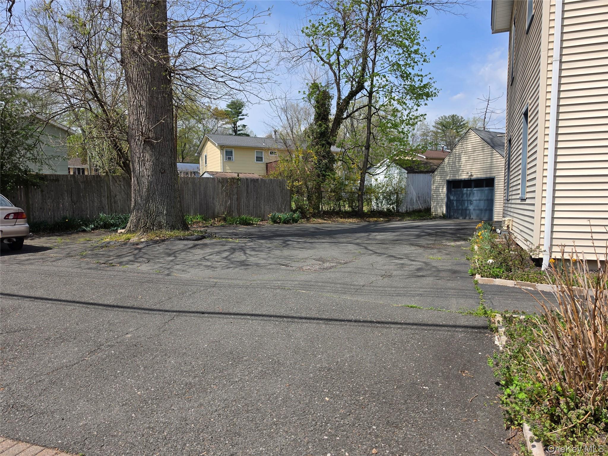 60 Main Street Tappan, NY 10983 - Photo 19 of 22 a wooden bench sitting in middle of a yard