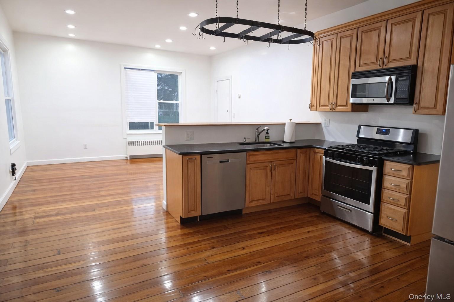 60 Main Street Tappan, NY 10983 - Photo 2 of 22 a kitchen with stainless steel appliances granite countertop a sink a stove top oven and wooden floors
