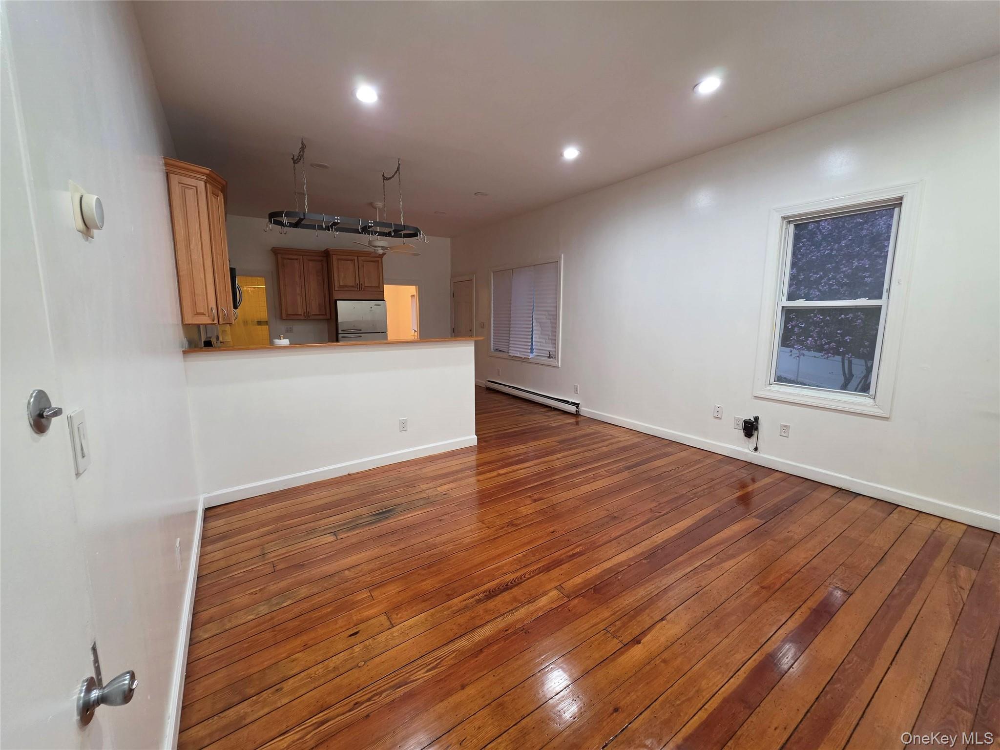 60 Main Street Tappan, NY 10983 - Photo 3 of 22 an empty room with wooden floor and a window
