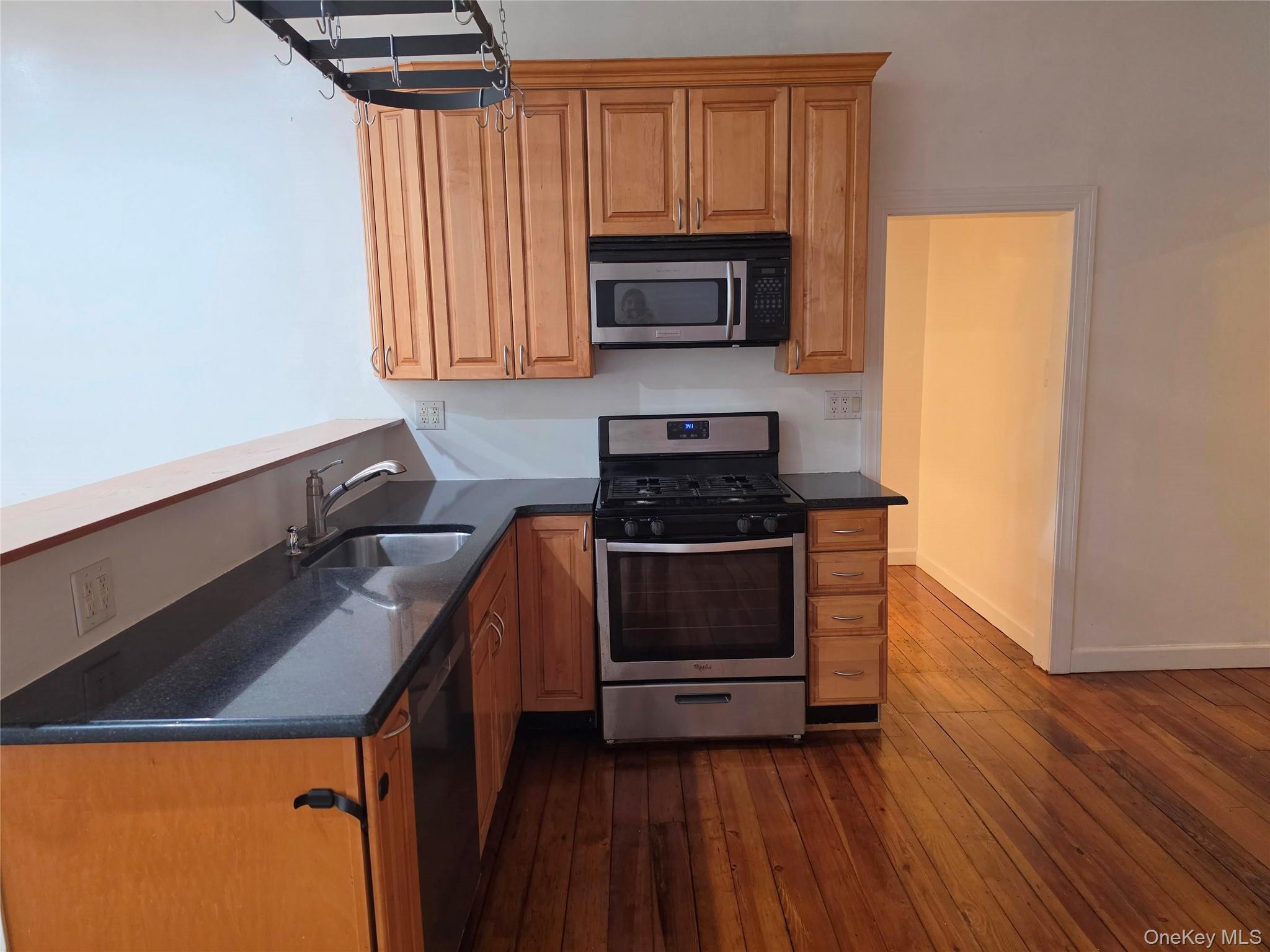 60 Main Street Tappan, NY 10983 - Photo 5 of 22 a kitchen with granite countertop a sink a stove top oven and cabinetry