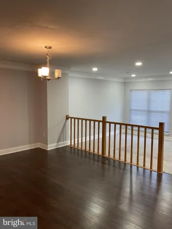 a view of a livingroom with furniture wooden floor and staircase