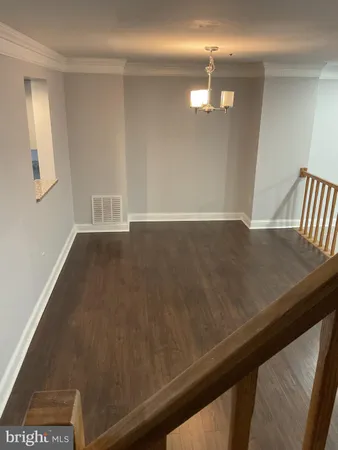 a view of hallway with couches and a fireplace