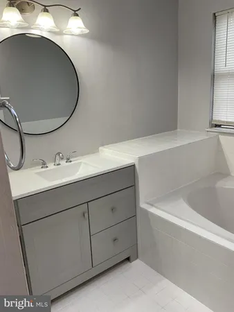 a bathroom with a sink and mirror