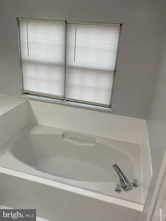 a bathroom with a shower and a glass door
