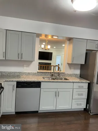 a kitchen with stainless steel appliances a refrigerator and a stove