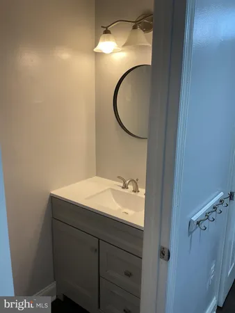 a white toilet sitting next to a white cabinet