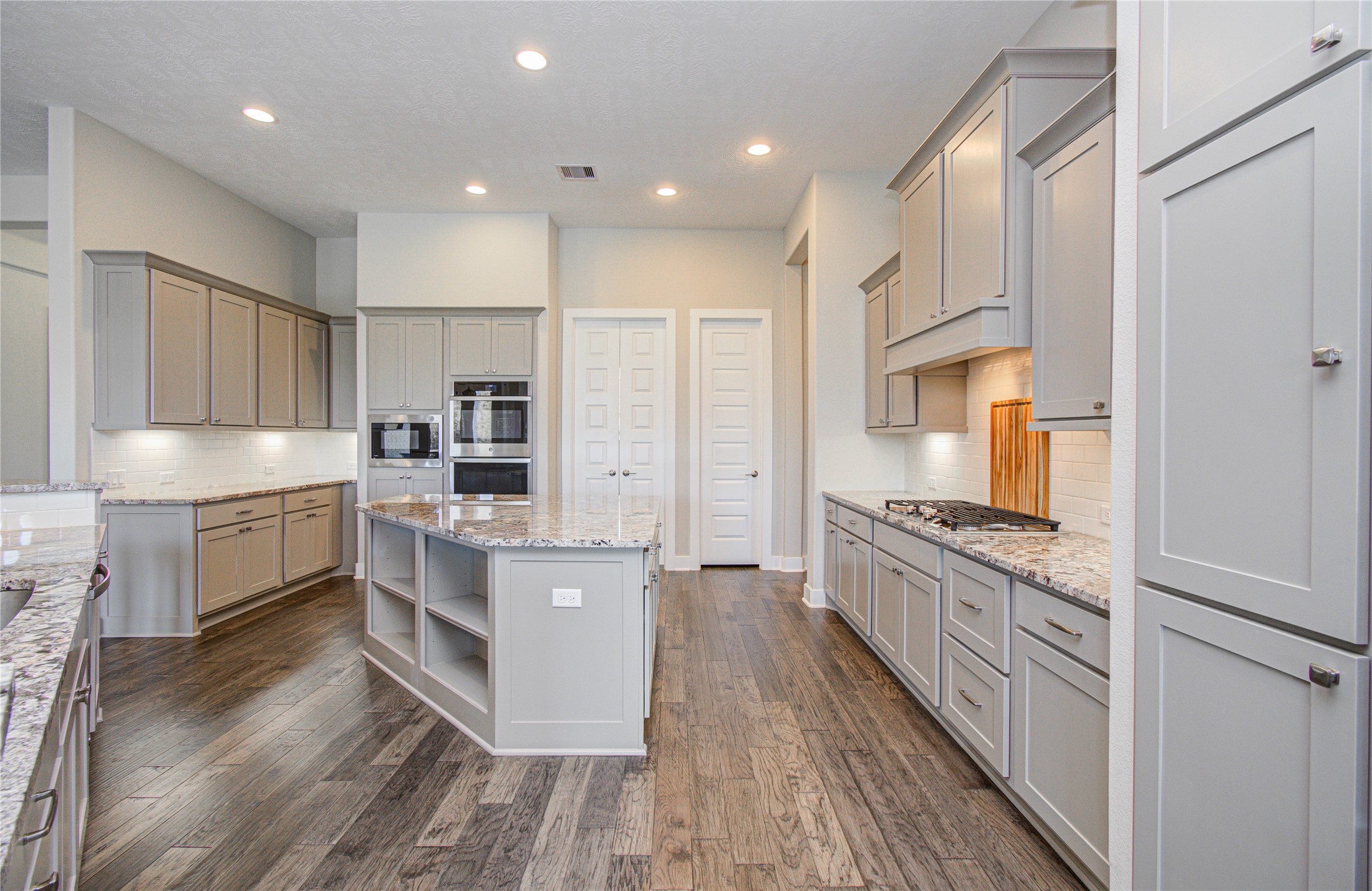 29702 Hay Field Lane Fulshear, TX 77406 - Photo 17 of 45 a large kitchen with stainless steel appliances sink a microwave and cabinets