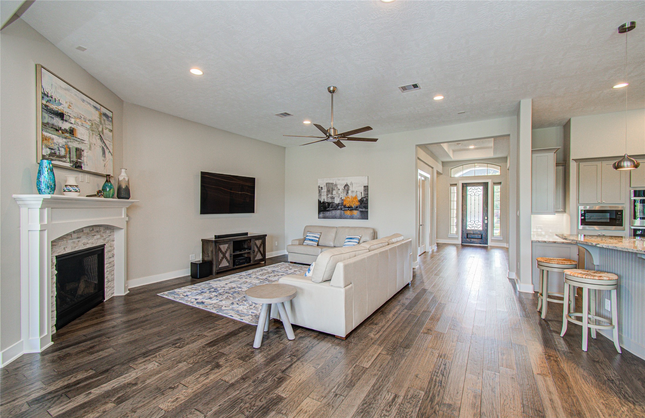 29702 Hay Field Lane Fulshear, TX 77406 - Photo 20 of 45 a living room with furniture a fireplace and a flat screen tv