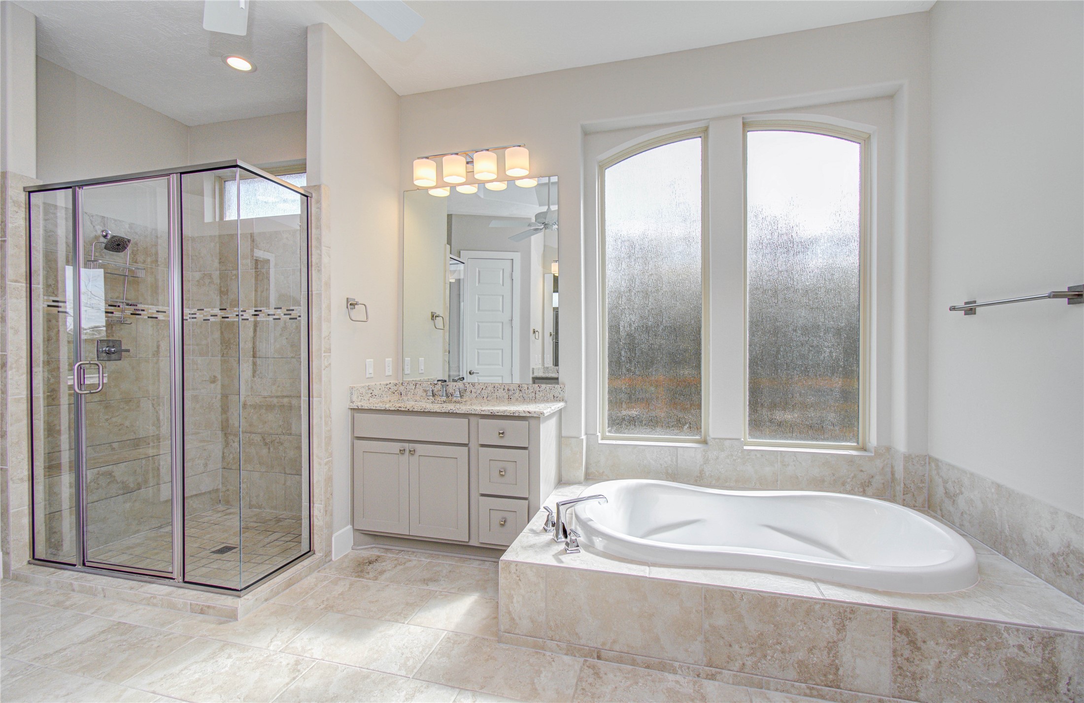 29702 Hay Field Lane Fulshear, TX 77406 - Photo 23 of 45 a spacious bathroom with a granite countertop tub shower and sink