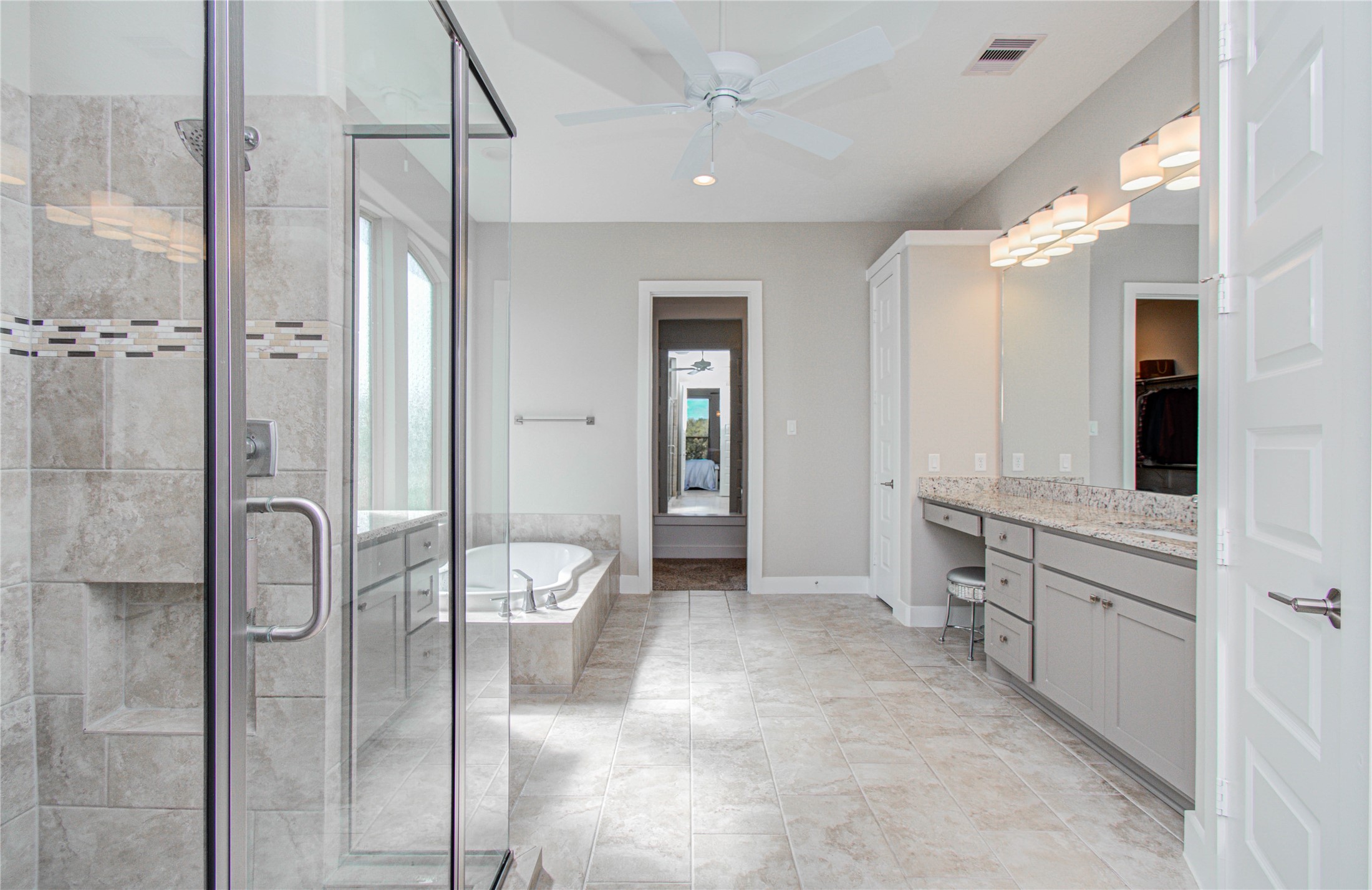 29702 Hay Field Lane Fulshear, TX 77406 - Photo 25 of 45 a bathroom with a double vanity sink toilet mirror and shower