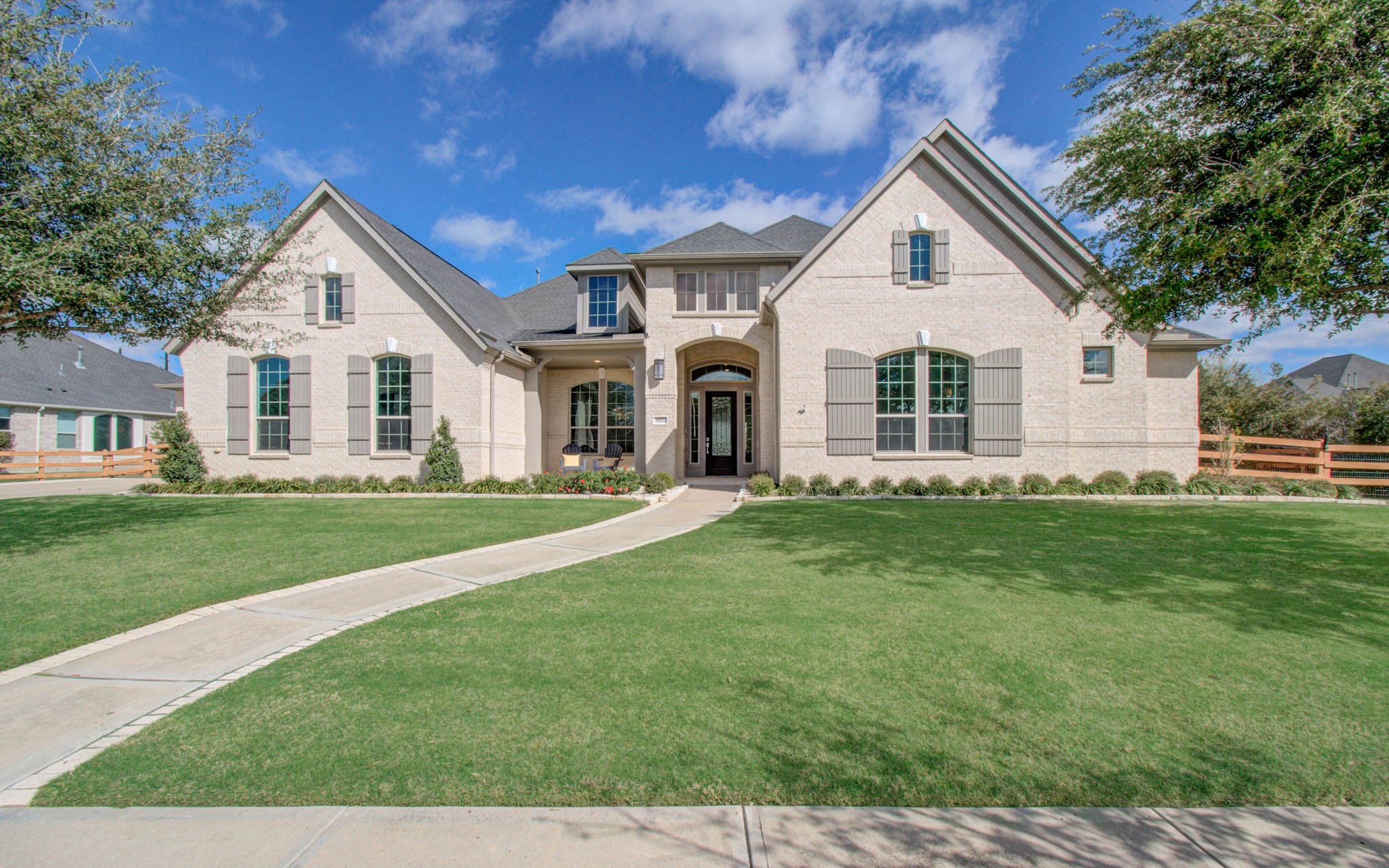 29702 Hay Field Lane Fulshear, TX 77406 - Photo 3 of 45 a front view of a house with a garden and porch