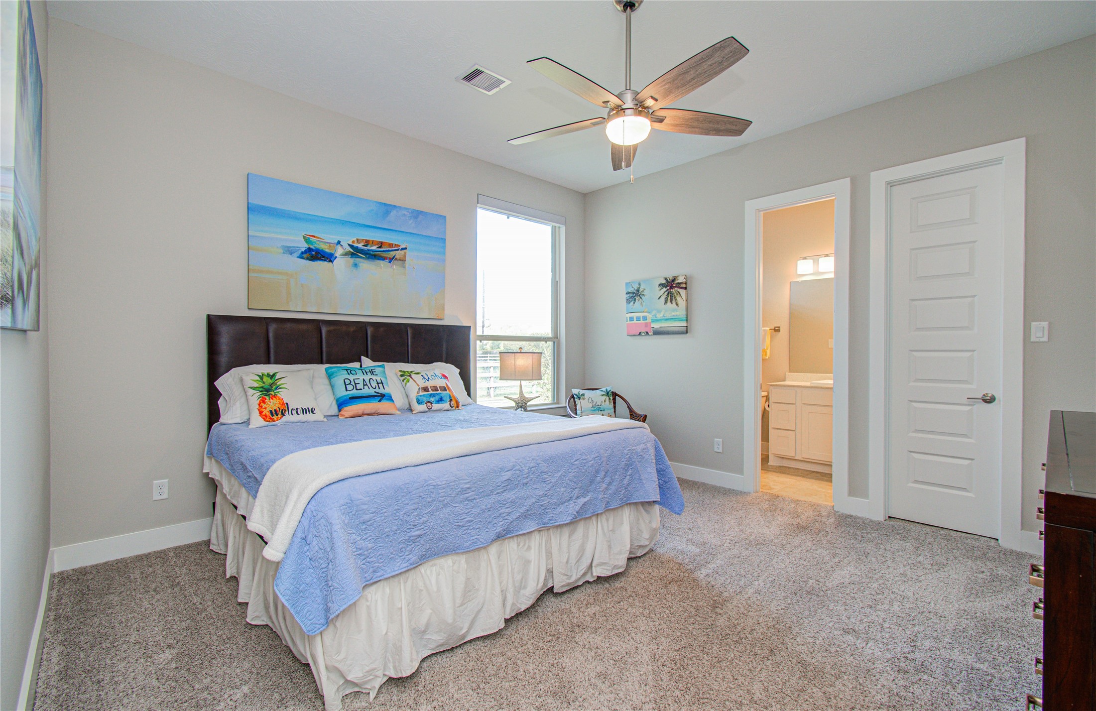 29702 Hay Field Lane Fulshear, TX 77406 - Photo 31 of 45 a bedroom with a bed and a chandelier
