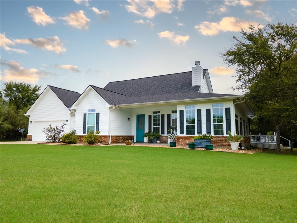 a front view of a house with a garden and plants