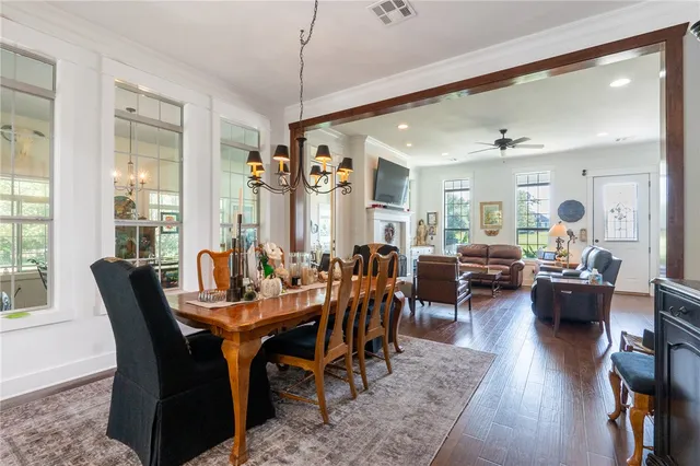 a view of a dining room and livingroom with furniture window and wooden floor