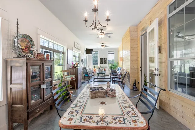 a living room with patio bathtub and a chandelier