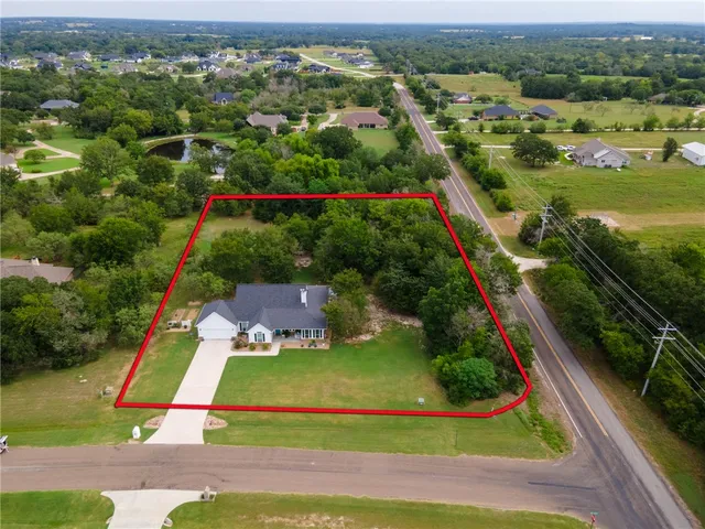 an aerial view of residential houses with outdoor space and river