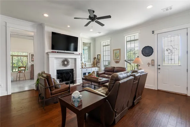 a living room with fireplace furniture and a flat screen tv