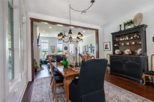 a view of a dining room with furniture and chandelier