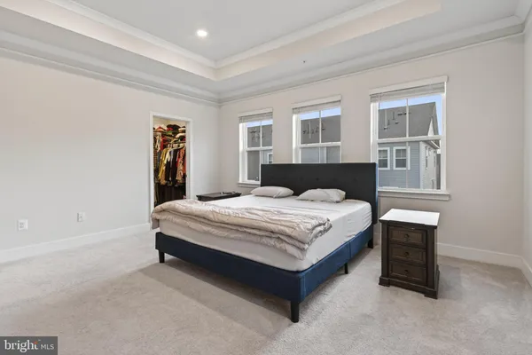 a spacious bedroom with a bed and a window