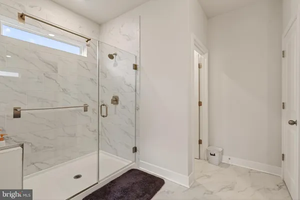 a bathroom with a glass shower door