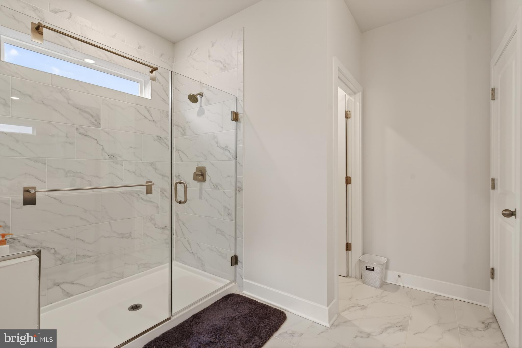 7201 Gringotts Way, Unit B Elkridge, MD 21075 - Photo 24 of 37 a bathroom with a glass shower door