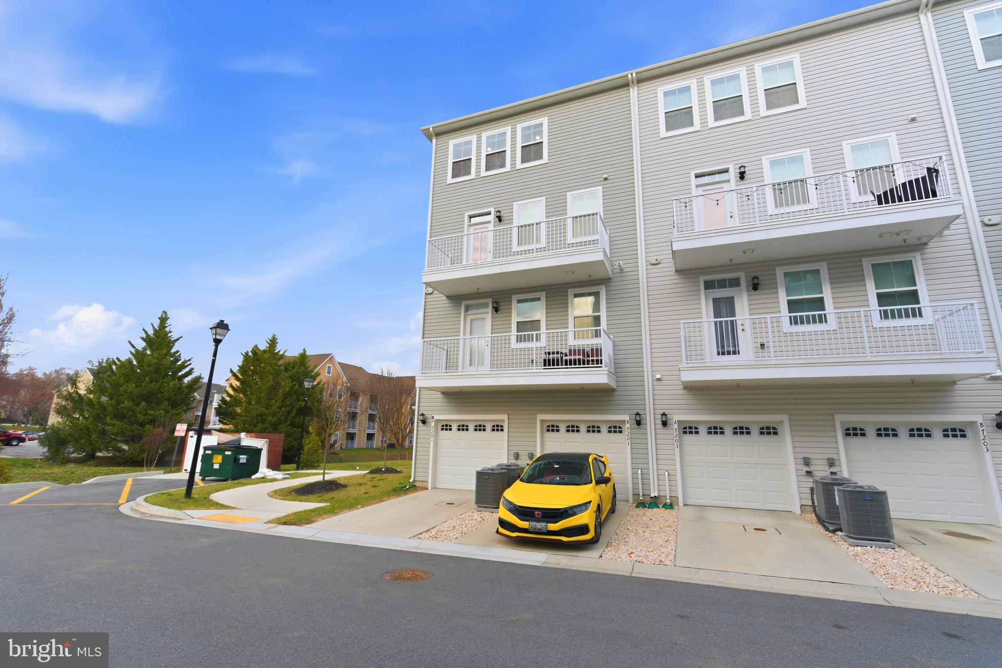 7201 Gringotts Way, Unit B Elkridge, MD 21075 - Photo 35 of 37 a view of a building with pool and chairs