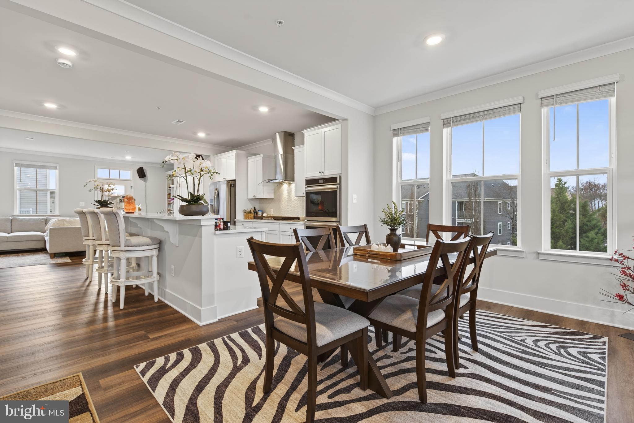 7201 Gringotts Way, Unit B Elkridge, MD 21075 - Photo 37 of 37 a view of a dining room with furniture window and wooden floor
