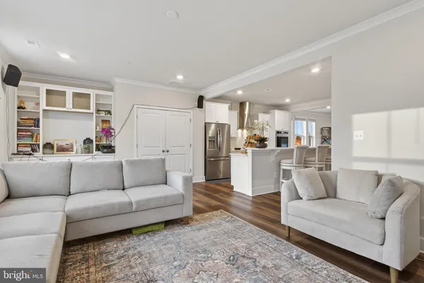 a living room with furniture and kitchen view