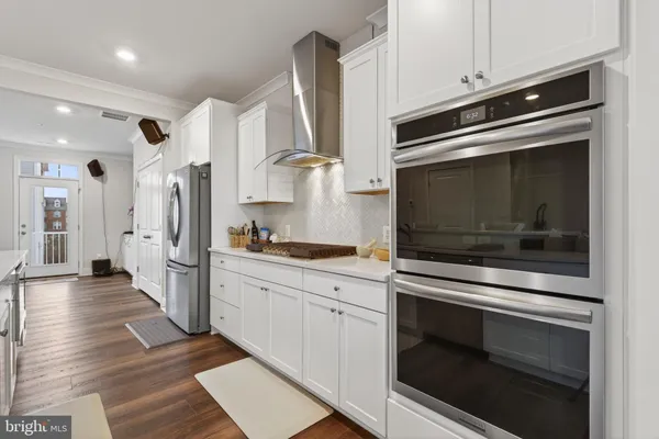 a kitchen with stainless steel appliances white cabinets and a stove