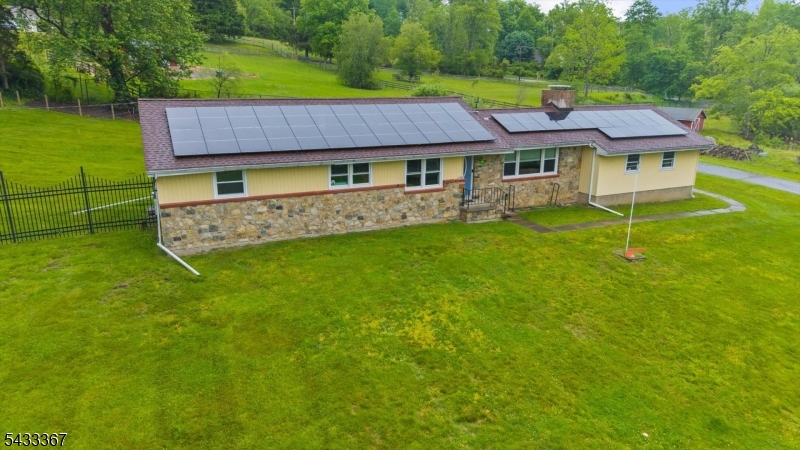 650 Woodglen Road Glen Gardner, NJ 08826 - Photo 1 of 28 a aerial view of a house with a yard table and chairs