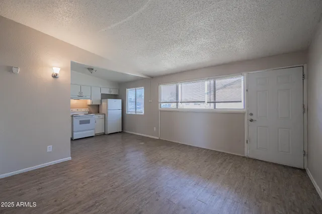 an empty room with windows and pillars in it