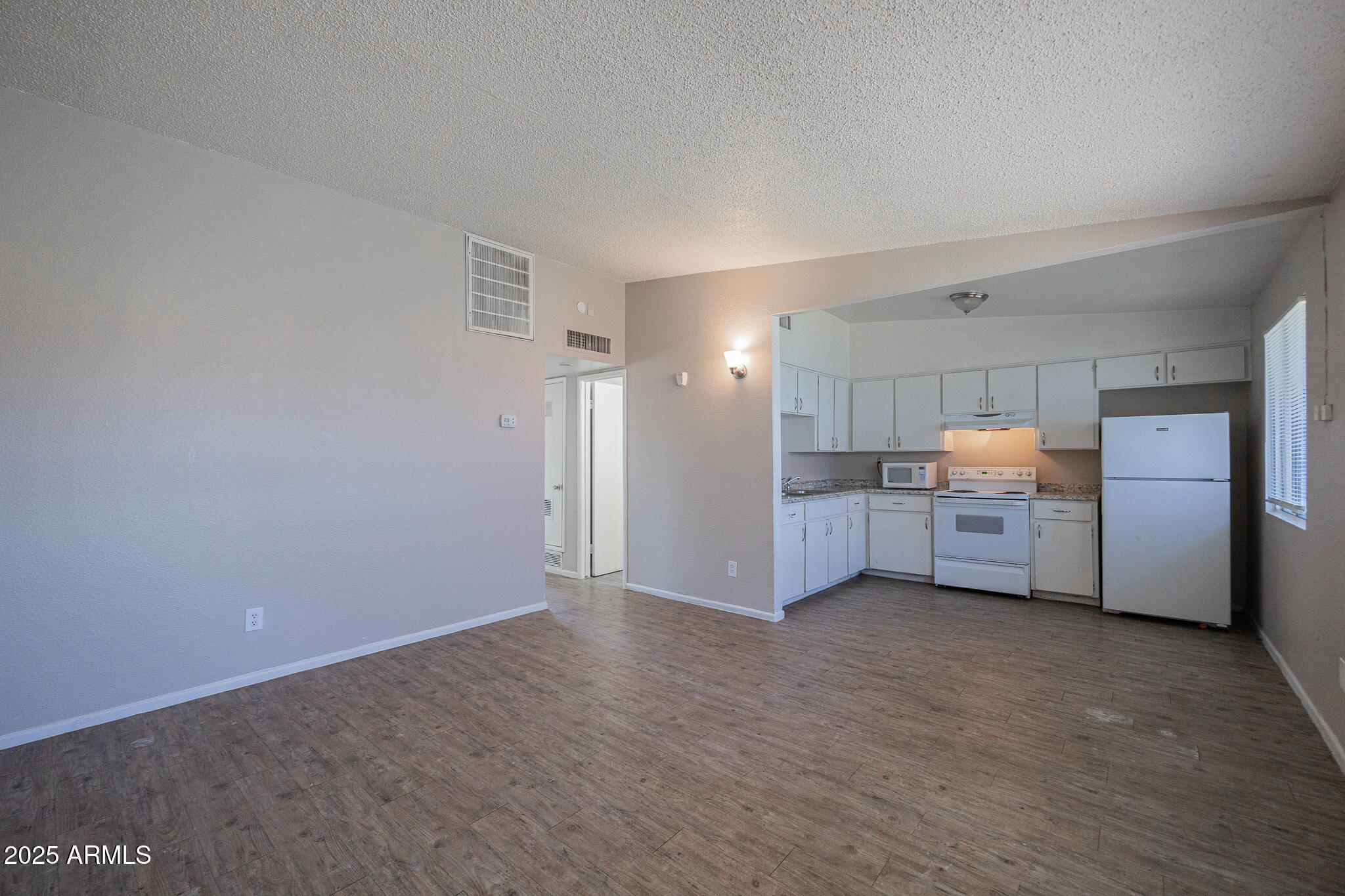 2139 West Devonshire Avenue, Unit 4 Phoenix, AZ 85015 - Photo 5 of 13 a view of a kitchen with refrigerator and cabinets