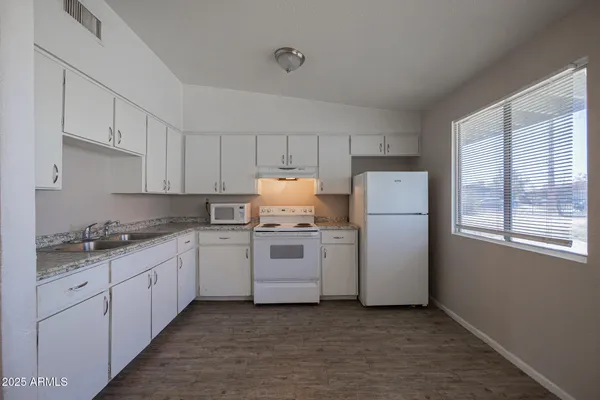 a kitchen with a white cabinets and white appliances