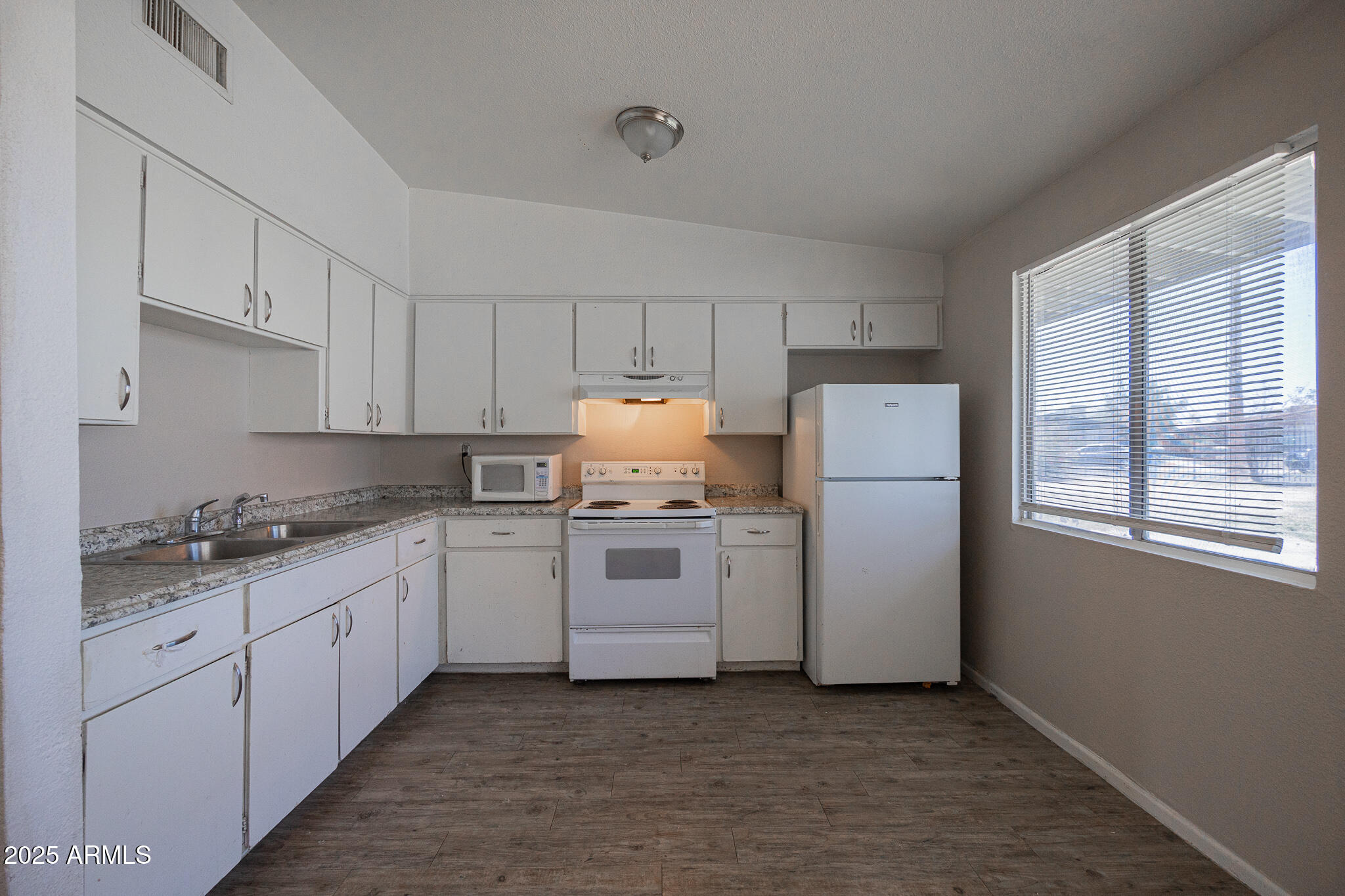2139 West Devonshire Avenue, Unit 4 Phoenix, AZ 85015 - Photo 8 of 13 a kitchen with a white cabinets and white appliances