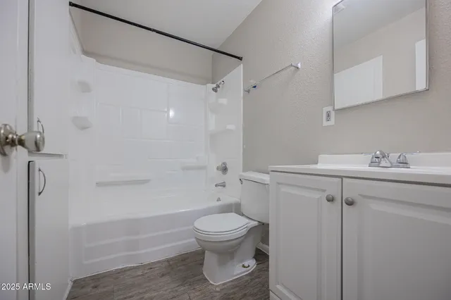 a bathroom with a toilet sink and shower