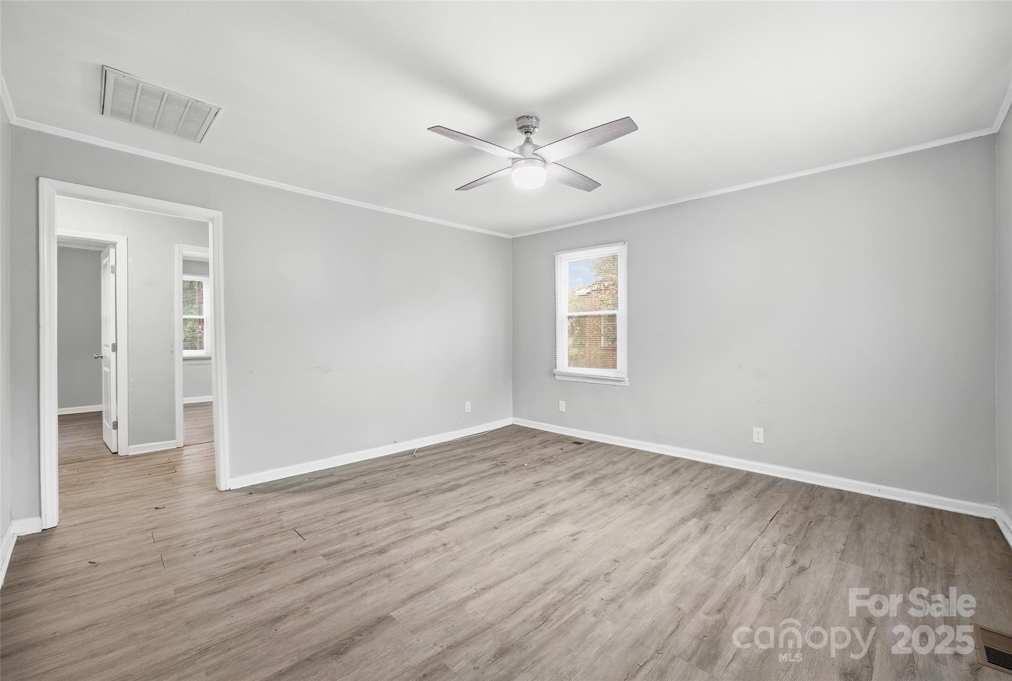 126 South Jackson Road Lancaster, SC 29720 - Photo 5 of 24 an empty room with wooden floor fan and windows