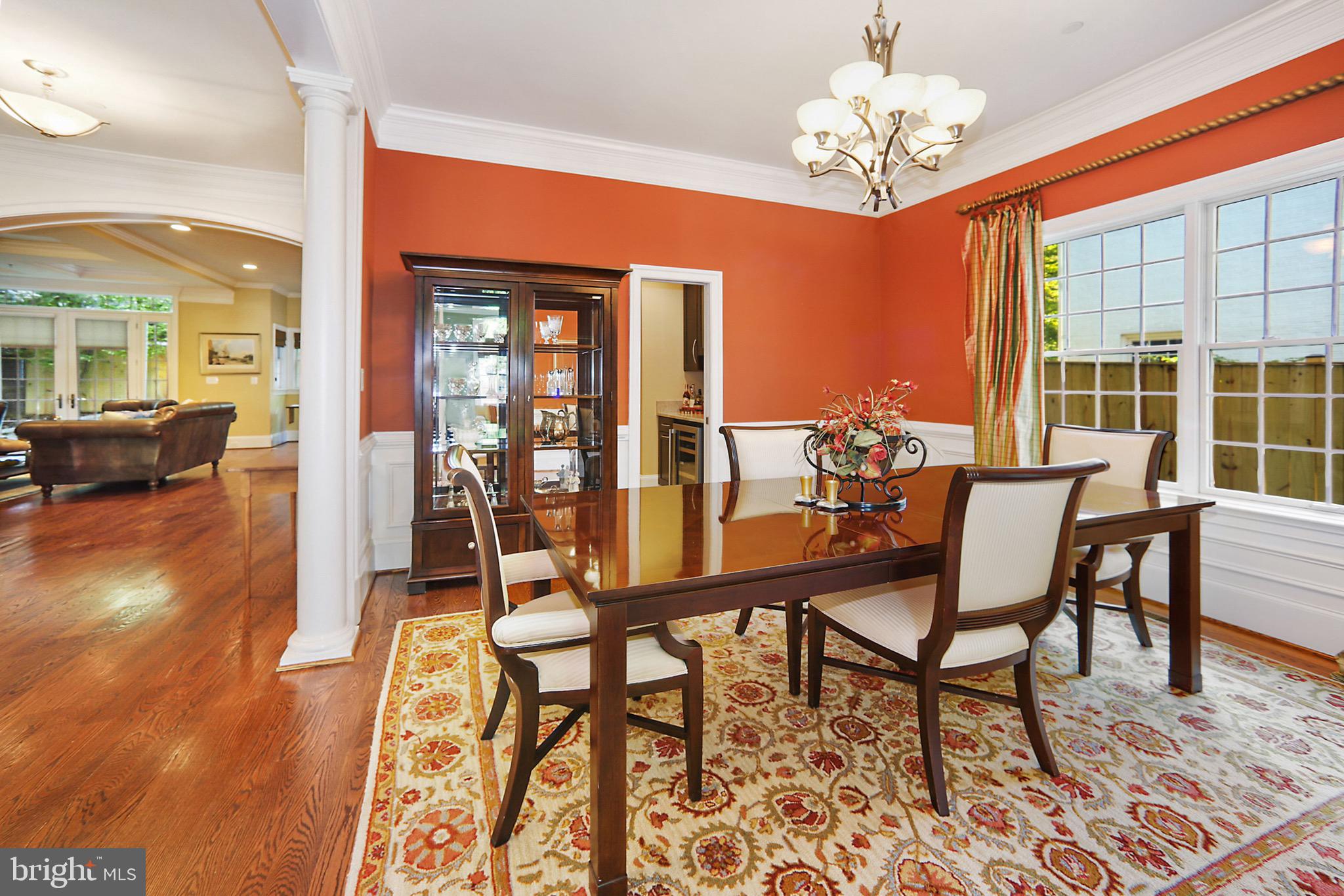 7117 Exfair Road Bethesda, MD 20814 - Photo 10 of 42 a view of a dining room with furniture wooden floor and a chandelier